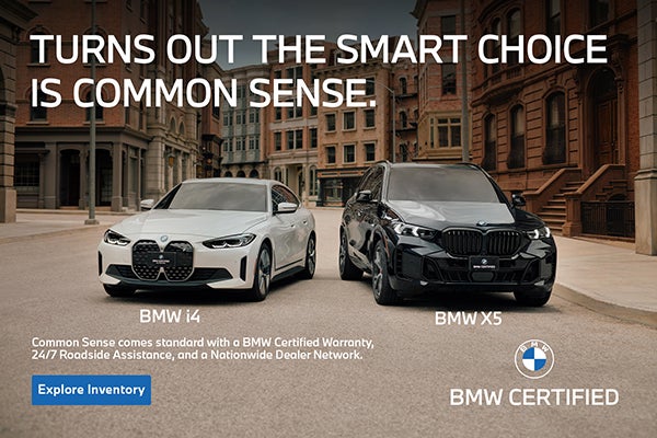 BMW i4 and BMW X5 parked on a city street.