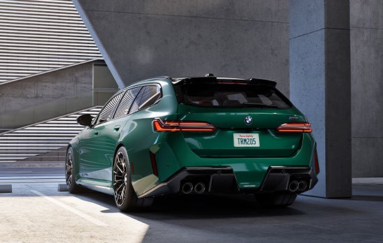 Green BMW M5 Touring parked in garage. | BMW of Dayton in Dayton OH